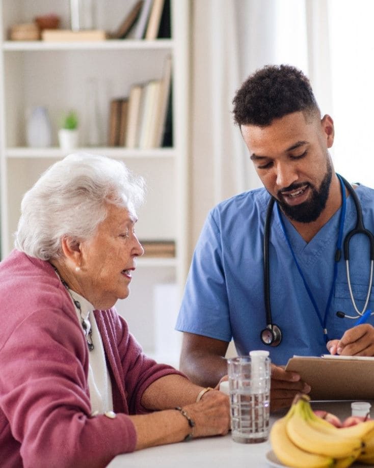 Nurse helping elderly man